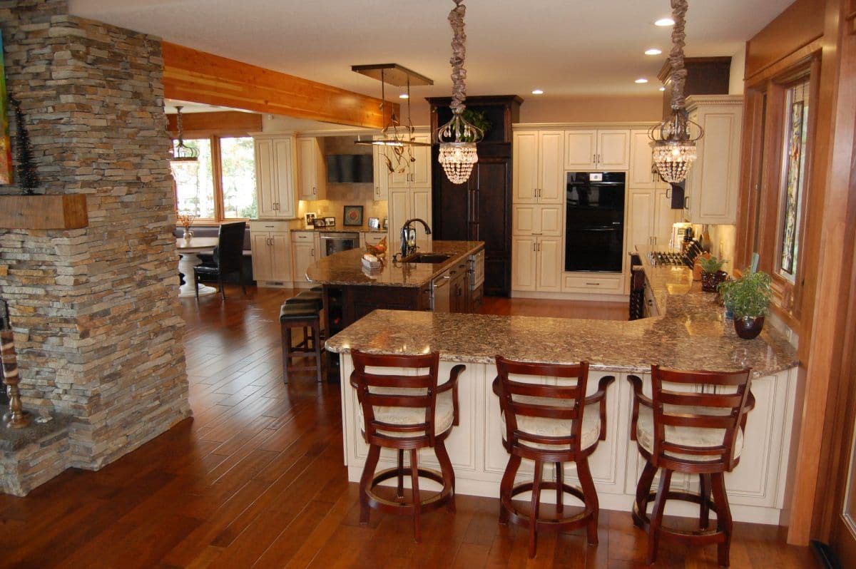 Custom kitchen cabinetry with glass-front upper cabinets and natural wood finish