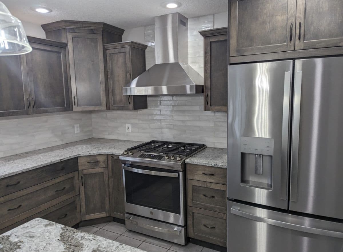 Traditional kitchen with white cabinetry and dark countertops