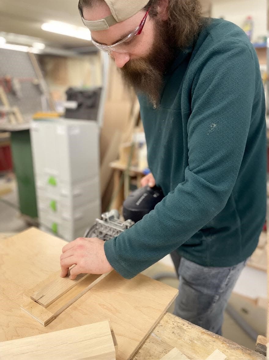 Lloyd’s Cabinet Shop founder, Lloyd, working on a cabinet project in the shop